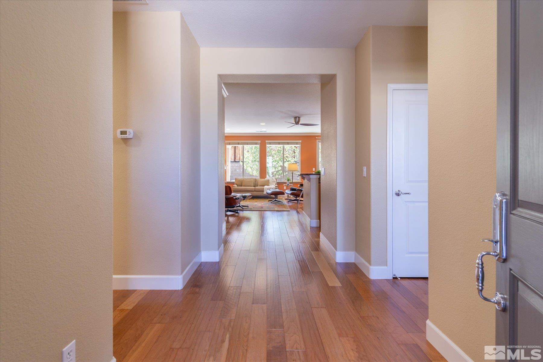 1375 Walking Stick Way Reno, NV 89523 - Photo 7 of 39 a view of a hallway view with wooden floor and a living room