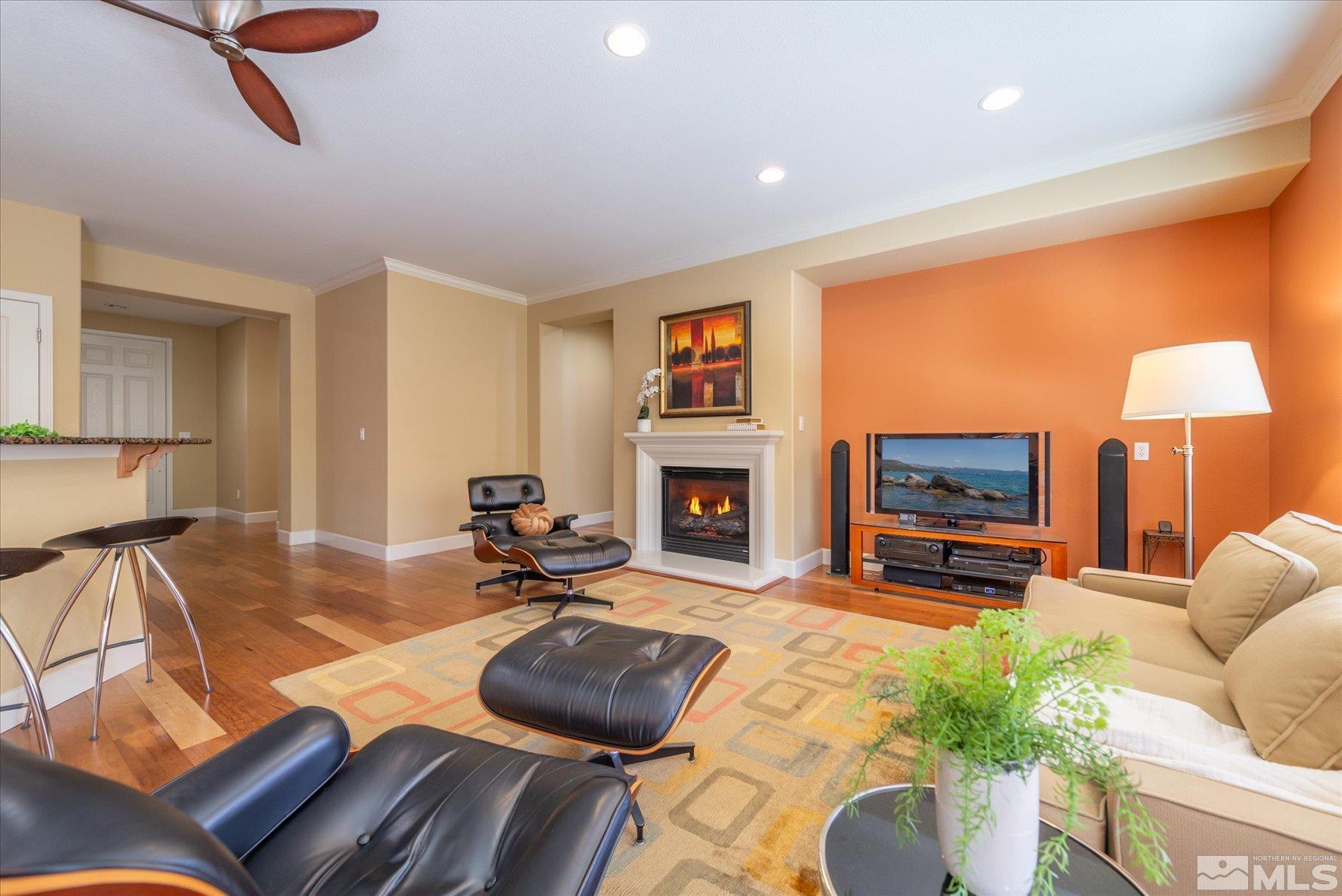 1375 Walking Stick Way Reno, NV 89523 - Photo 10 of 39 a living room with furniture a fireplace and a flat screen tv