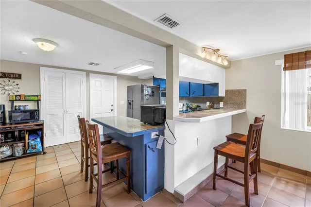 a room with furniture a rug toys and a book shelf