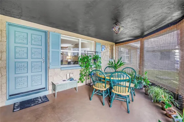 a view of a backyard with plants and outdoor seating