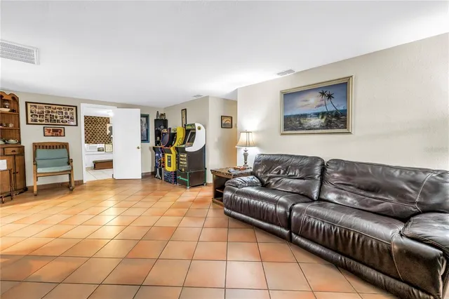 a kitchen with a dining table chairs and refrigerator