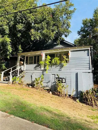 a view of a patio with table and chairs under an umbrella