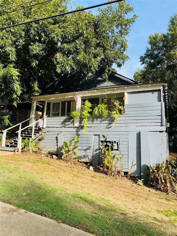 a view of a patio with table and chairs under an umbrella