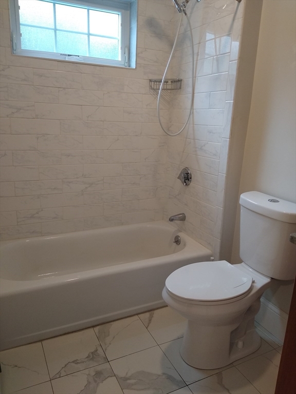 134 Jackson Street Cambridge, MA 02140 - Photo 15 of 22 a white toilet sitting next to a bath tub and a shower