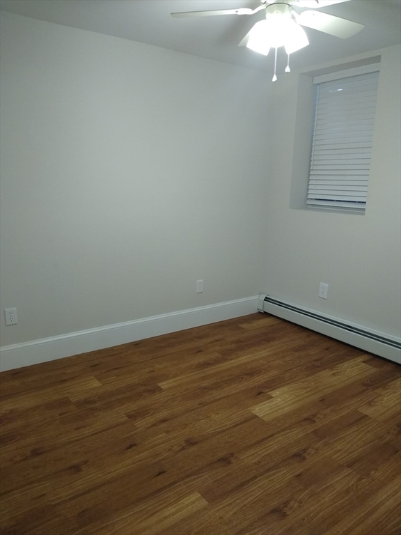 134 Jackson Street Cambridge, MA 02140 - Photo 19 of 22 a view of a room with wooden floor and fan