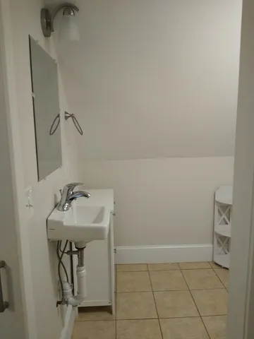 a bathroom with a sink toilet and mirror