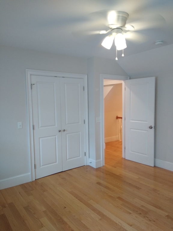 134 Jackson Street Cambridge, MA 02140 - Photo 9 of 22 a view of an empty room with a chandelier fan