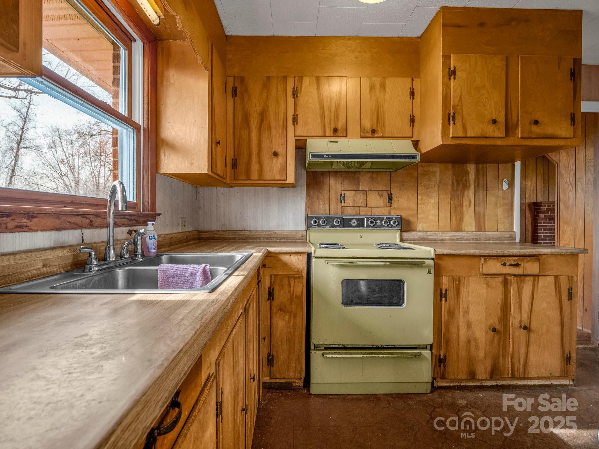 6 Rachel Bell Road Mill Spring, NC 28756 - Photo 11 of 41 a kitchen with stainless steel appliances granite countertop a stove a sink and a microwave