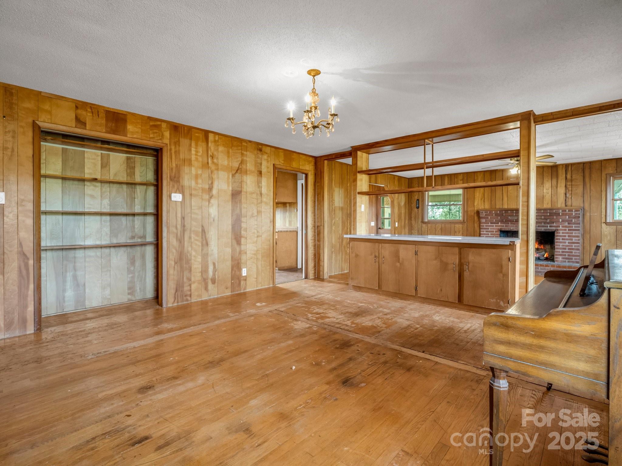 6 Rachel Bell Road Mill Spring, NC 28756 - Photo 17 of 41 a view of a livingroom with furniture a chandelier and wooden floor