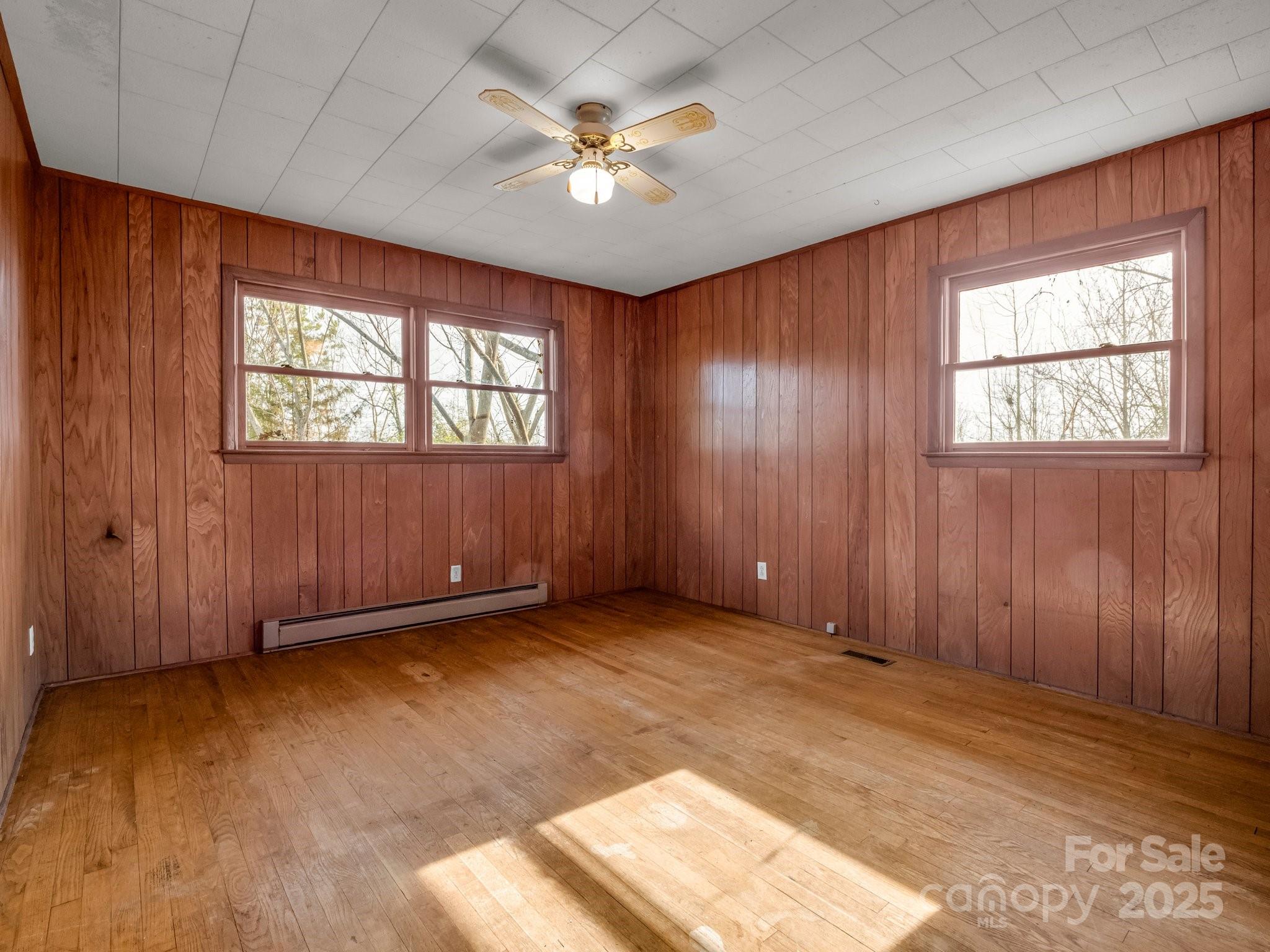 6 Rachel Bell Road Mill Spring, NC 28756 - Photo 22 of 41 an empty room with windows and ceiling fan