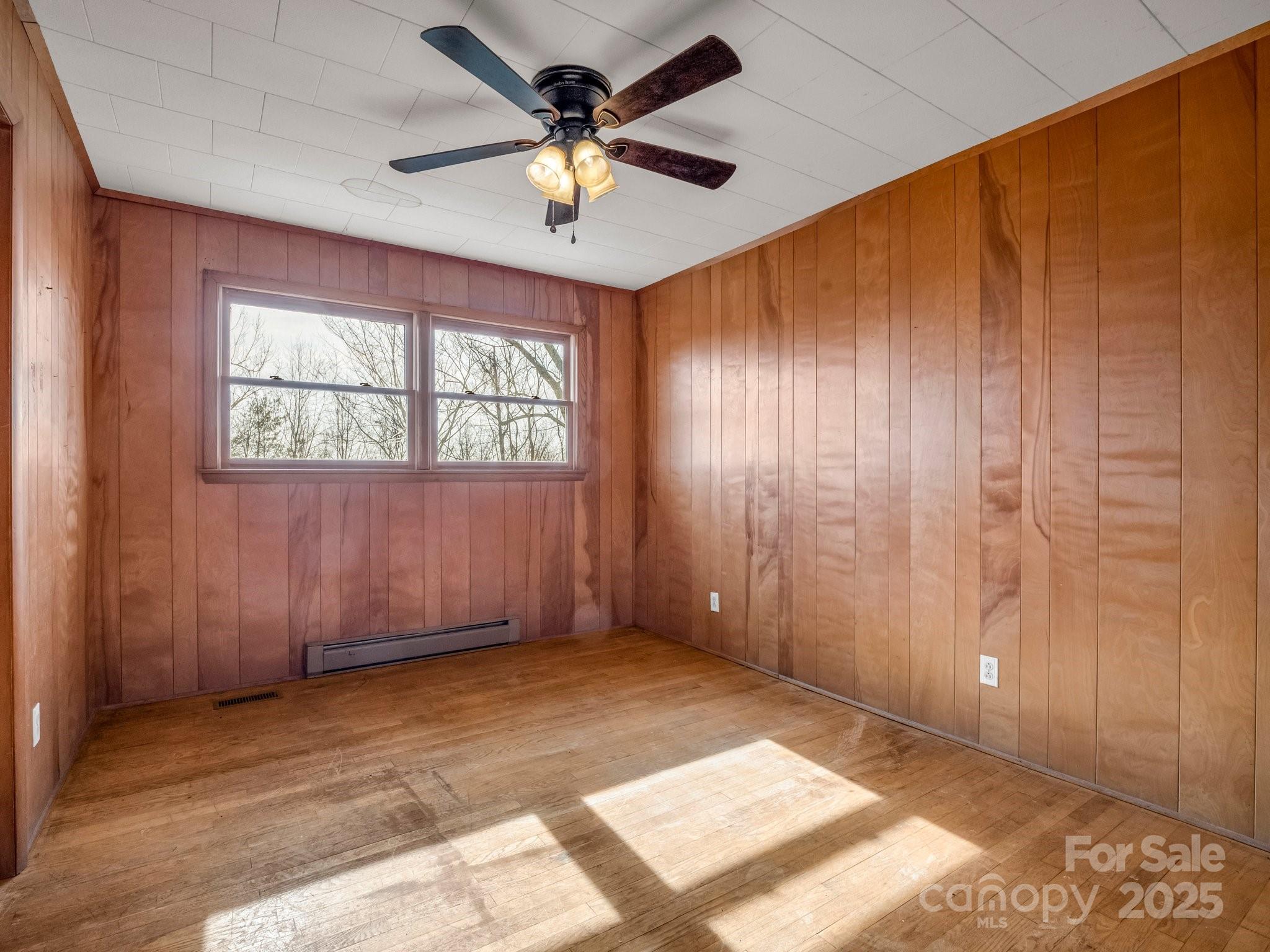 6 Rachel Bell Road Mill Spring, NC 28756 - Photo 24 of 41 an empty room with windows and fan