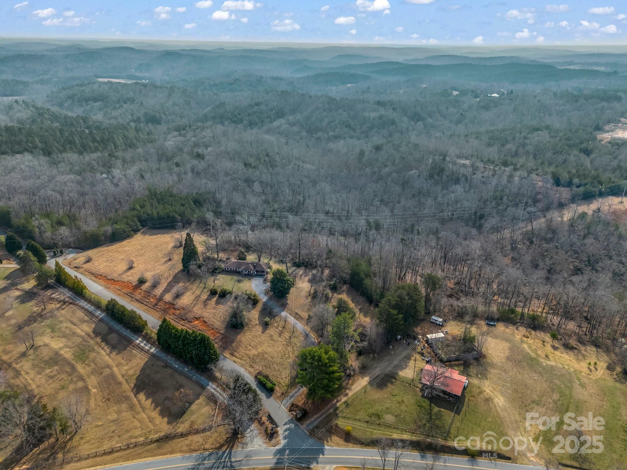 6 Rachel Bell Road Mill Spring, NC 28756 - Photo 35 of 41 a view of a backyard with barn and green space