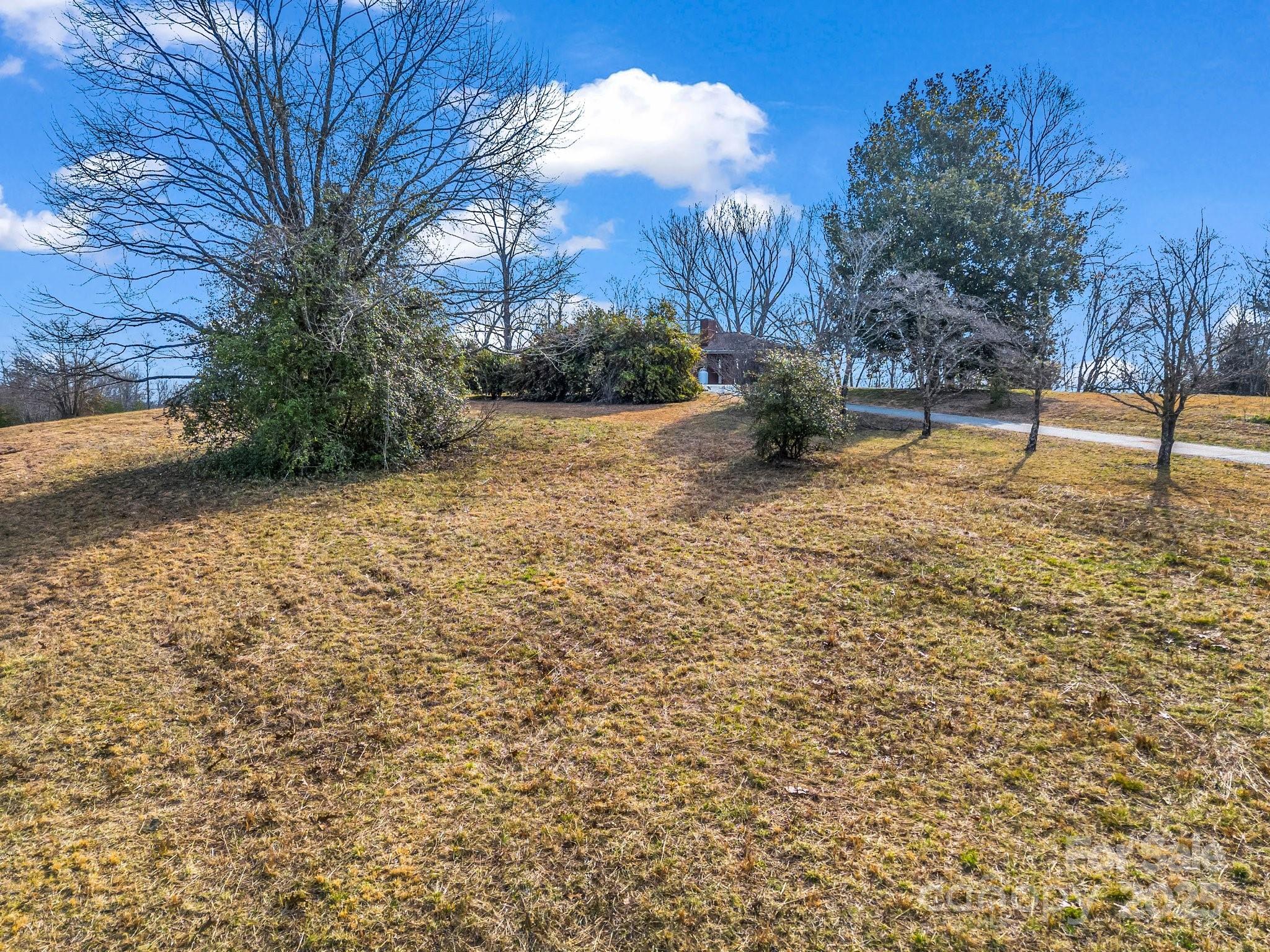 6 Rachel Bell Road Mill Spring, NC 28756 - Photo 37 of 41 a view of a yard with a house