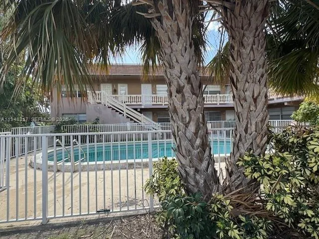 a front view of a house with a tree