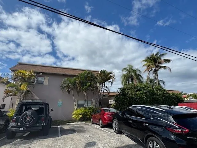 a view of a cars park in front of a building