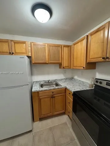 a kitchen with granite countertop cabinets and steel stainless steel appliances