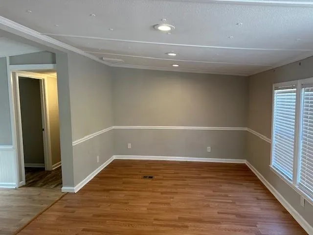 a view of room with window and hardwood floor
