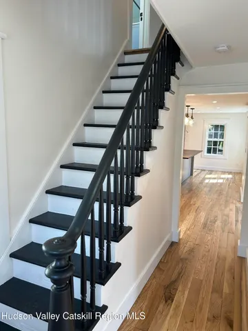 a view of entryway and hall with wooden floor