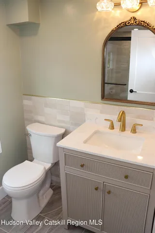 a white toilet sitting next to a bathroom sink