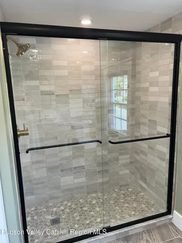 a bathroom with a glass shower door