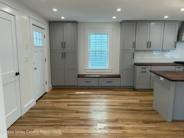 a view of a kitchen with a sink and cabinets