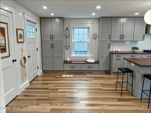 a view of a kitchen with kitchen island and stainless steel appliances