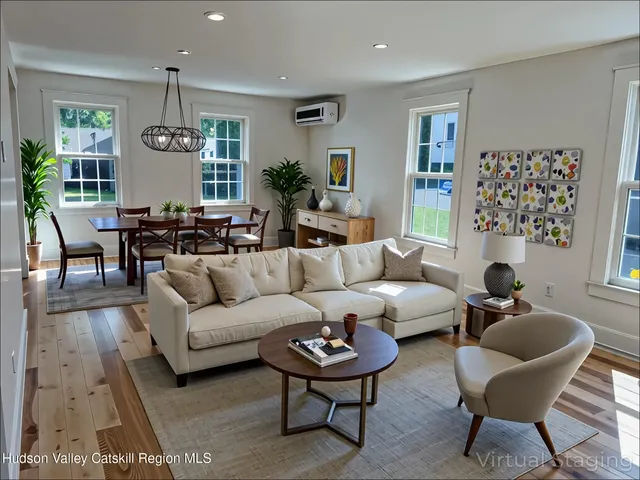 a living room with furniture potted plant and window