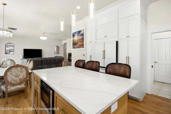 a living room with furniture a flat screen tv and a table