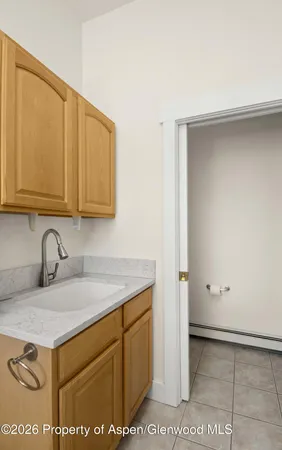 a view of a sink storage and utility room