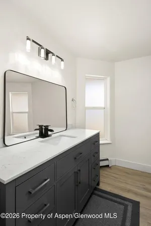 a bathroom with a sink a mirror and vanity