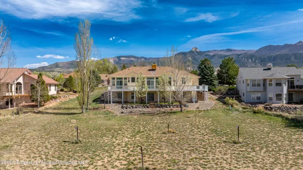 a view of a big house with a yard