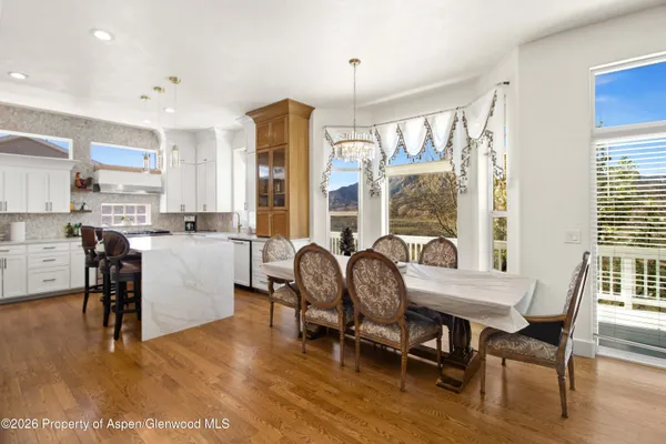 a view of a dining room with furniture window and wooden floor