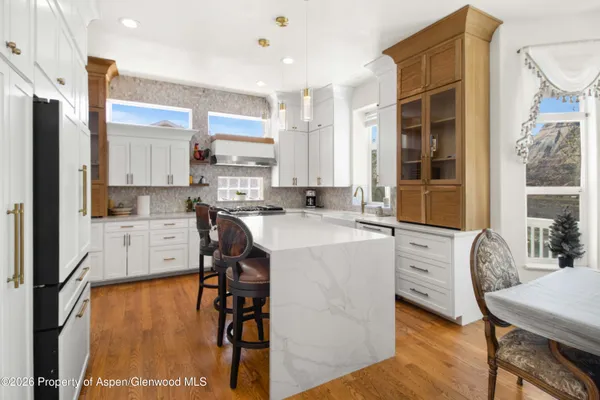 a kitchen with stainless steel appliances a stove a sink refrigerator and cabinets