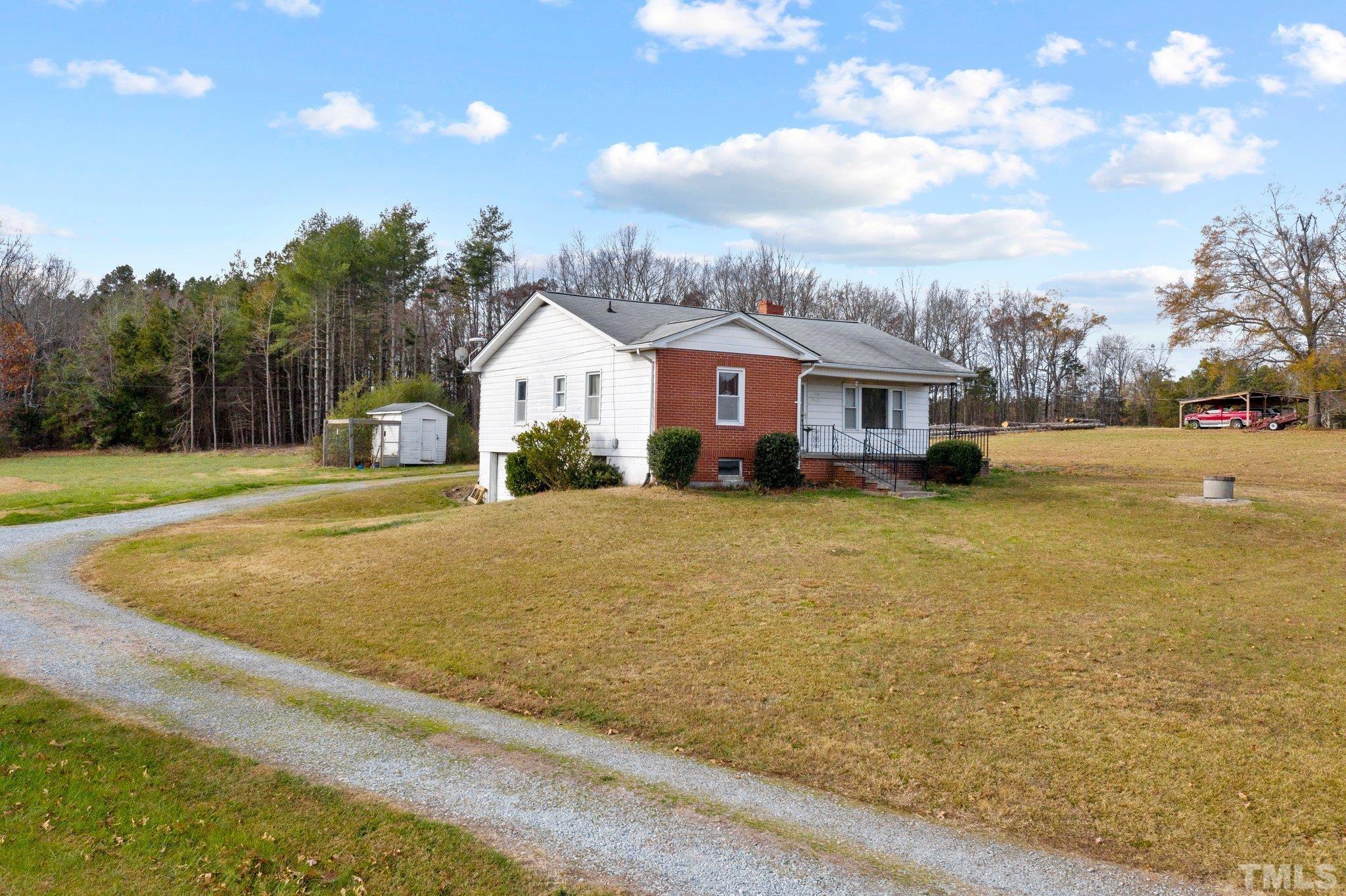 4966 Oxford Road Roxboro, NC 27574 - Photo 5 of 6 a front view of a house with a yard and trees