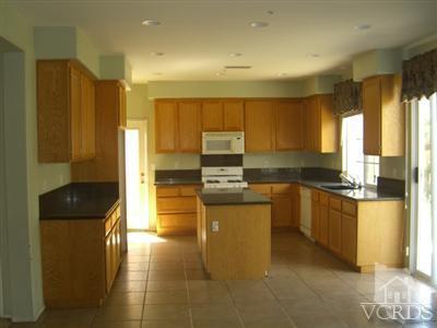2043 Ribera Drive Oxnard, CA 93030 - Photo 4 of 17 a kitchen with stainless steel appliances granite countertop a refrigerator a stove and a sink