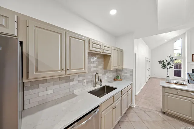 a kitchen with stainless steel appliances a sink stove and refrigerator