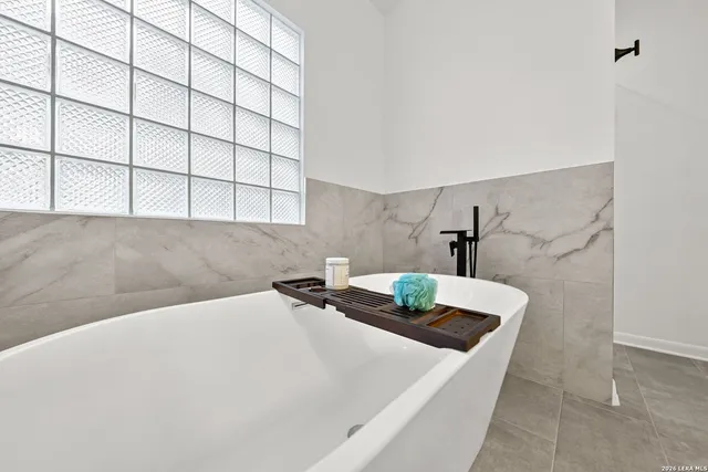 a bathroom with a sink a vanity and a shower