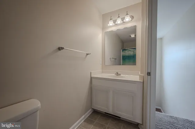 a bathroom with a sink a toilet and mirror