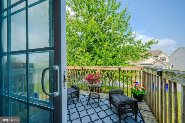 a view of a balcony with wooden chairs