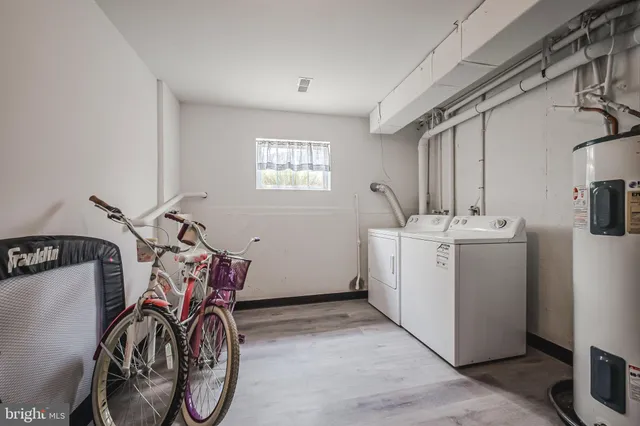 a view of swimming pool with outdoor seating and house in the background
