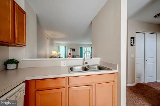 a kitchen with a sink cabinets and a window