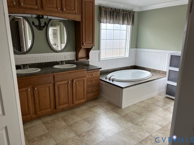 15910 Nobles Road Disputanta, VA 23842 - Photo 32 of 38 Full bathroom with wainscoting, double vanity, a b