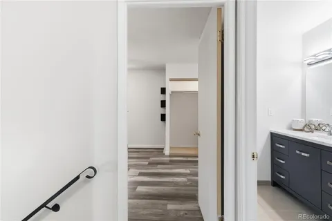 a view of a hallway with closet and front door