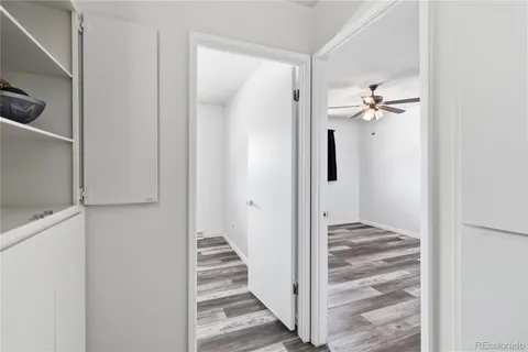 a view of a hallway with wooden floor and staircase