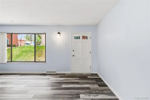 a view of a livingroom with an empty space and window
