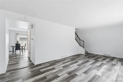 a view of a room with wooden floor