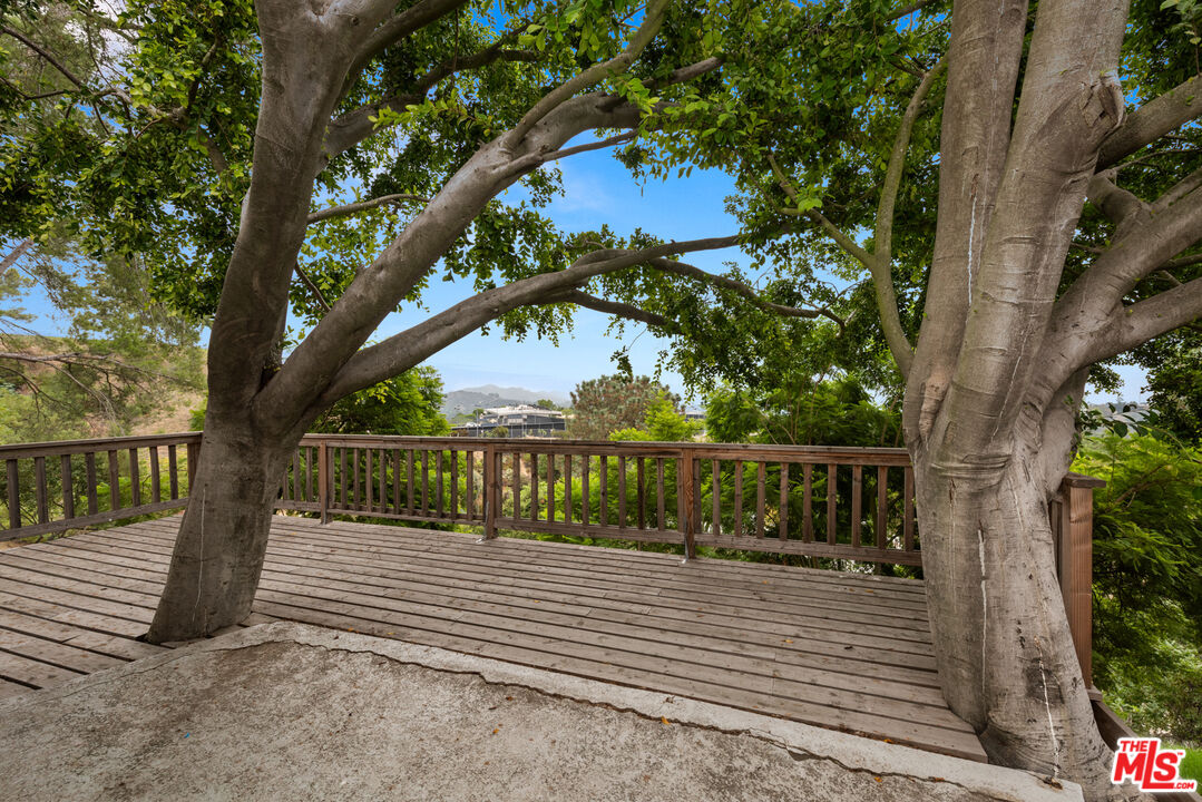2526 Briarcrest Road Beverly Hills, CA 90210 - Photo 12 of 15 a balcony with trees in front of it