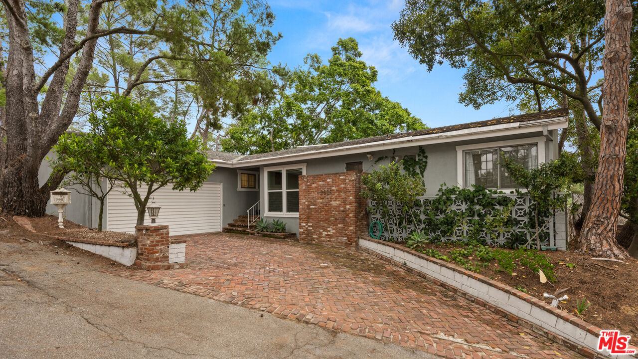 2526 Briarcrest Road Beverly Hills, CA 90210 - Photo 4 of 15 a house with trees in front of it
