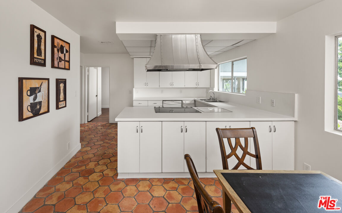 2526 Briarcrest Road Beverly Hills, CA 90210 - Photo 7 of 15 a kitchen with stainless steel appliances granite countertop a sink stove and cabinets