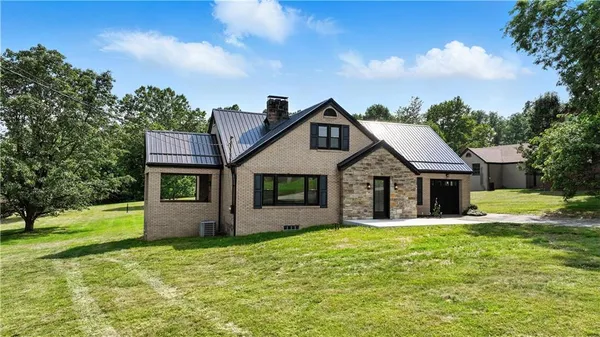 a front view of house with yard and green space